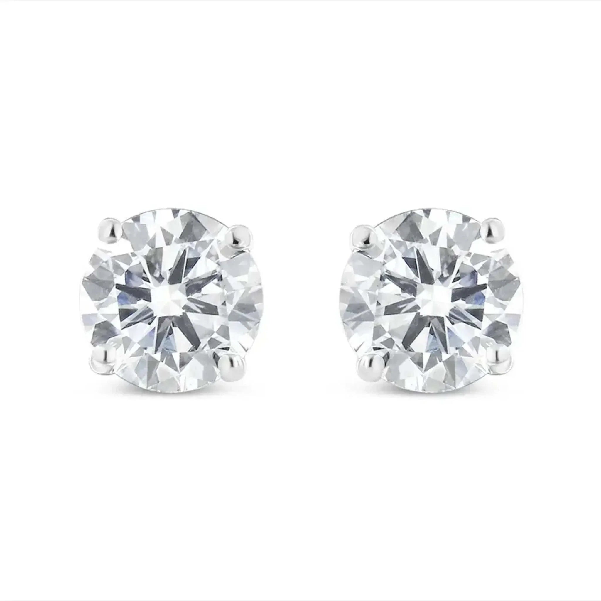 10K white gold stud earrings with 1.00 Cttw round brilliant-cut near colorless diamonds in 4-prong settings.