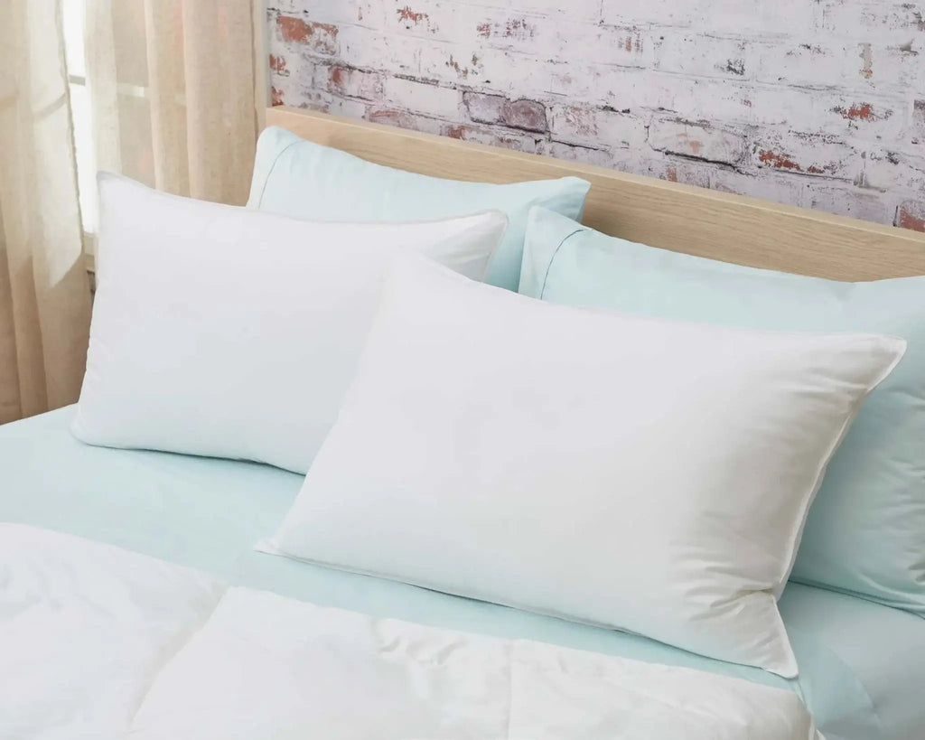 Premium white down alternative pillow with soft cotton sateen cover on bed.