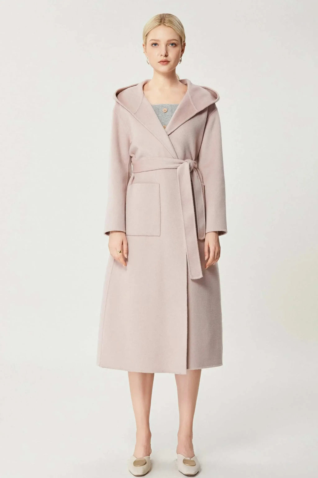 Baby pink A-line cashmere coat with lapel collar and belt.