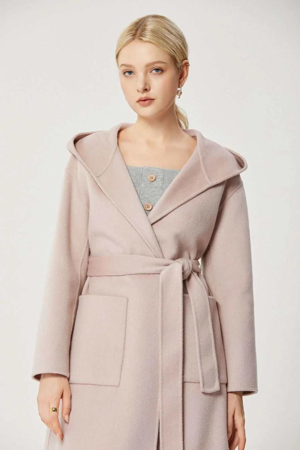 Baby pink cashmere A-line coat with lapel collar and matching belt.