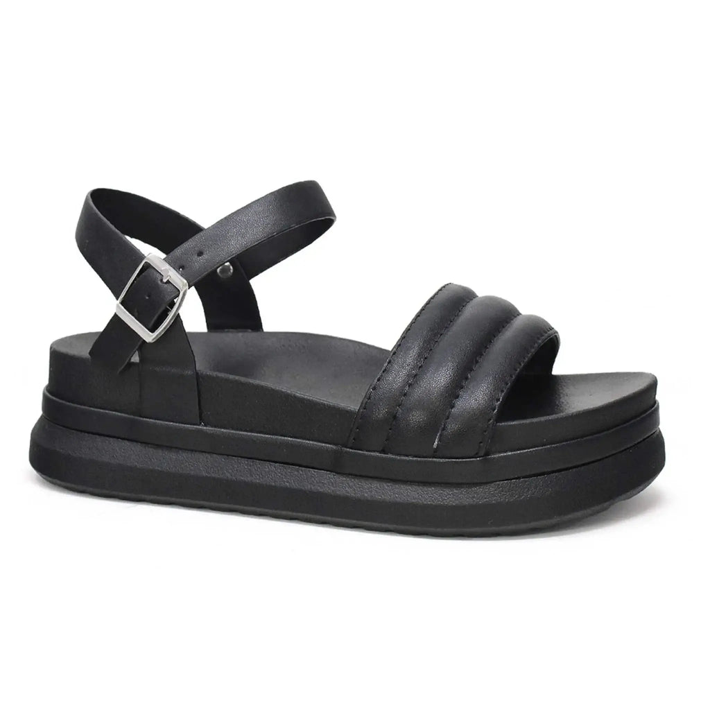 Women's black sandal with puff seam design and adjustable ankle strap.