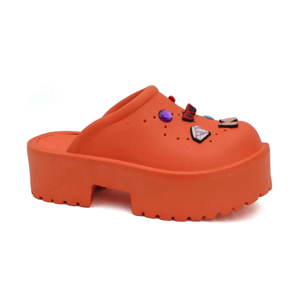 Women's orange platform clog sandals with removable decorative pins.