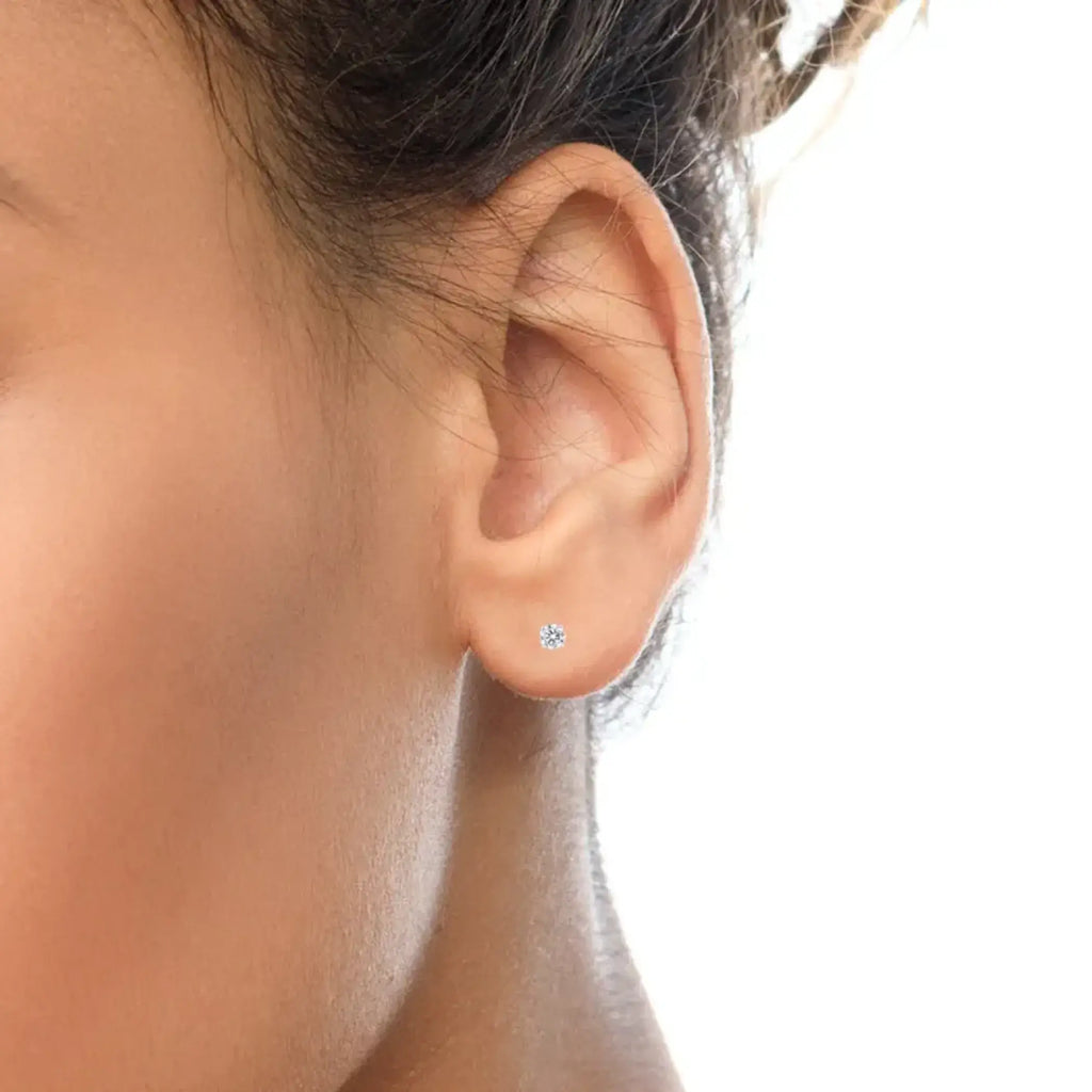 10K white gold stud earrings with round brilliant-cut diamonds in prong settings.