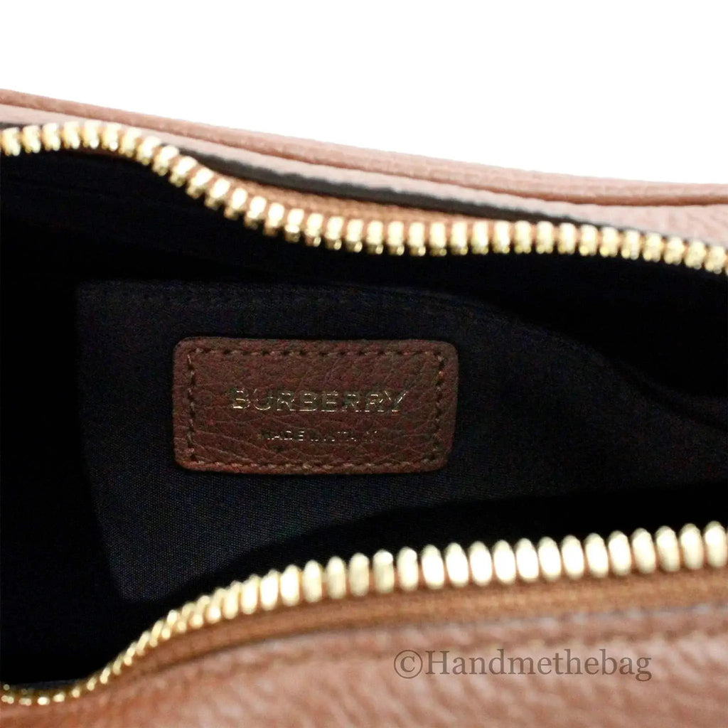 Burberry small tan leather camera crossbody bag interior with logo tag and gold zipper.