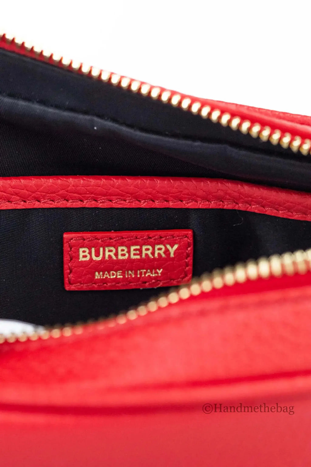 Burberry small red leather camera crossbody bag with luxury pebbled leather and adjustable strap.