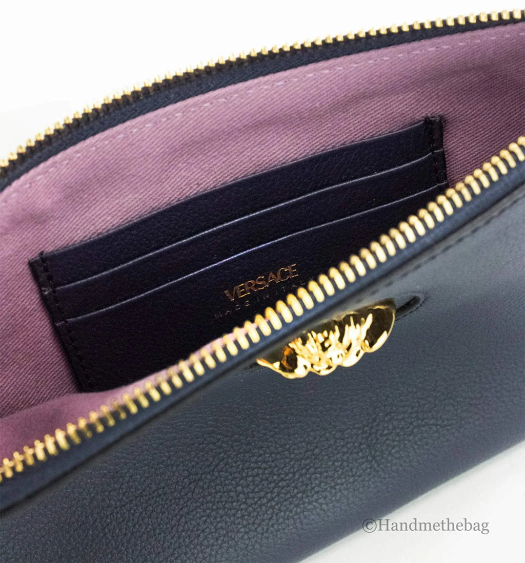 Versace small navy pebbled leather wristlet clutch pouch with detachable wrist strap and inner card slots.