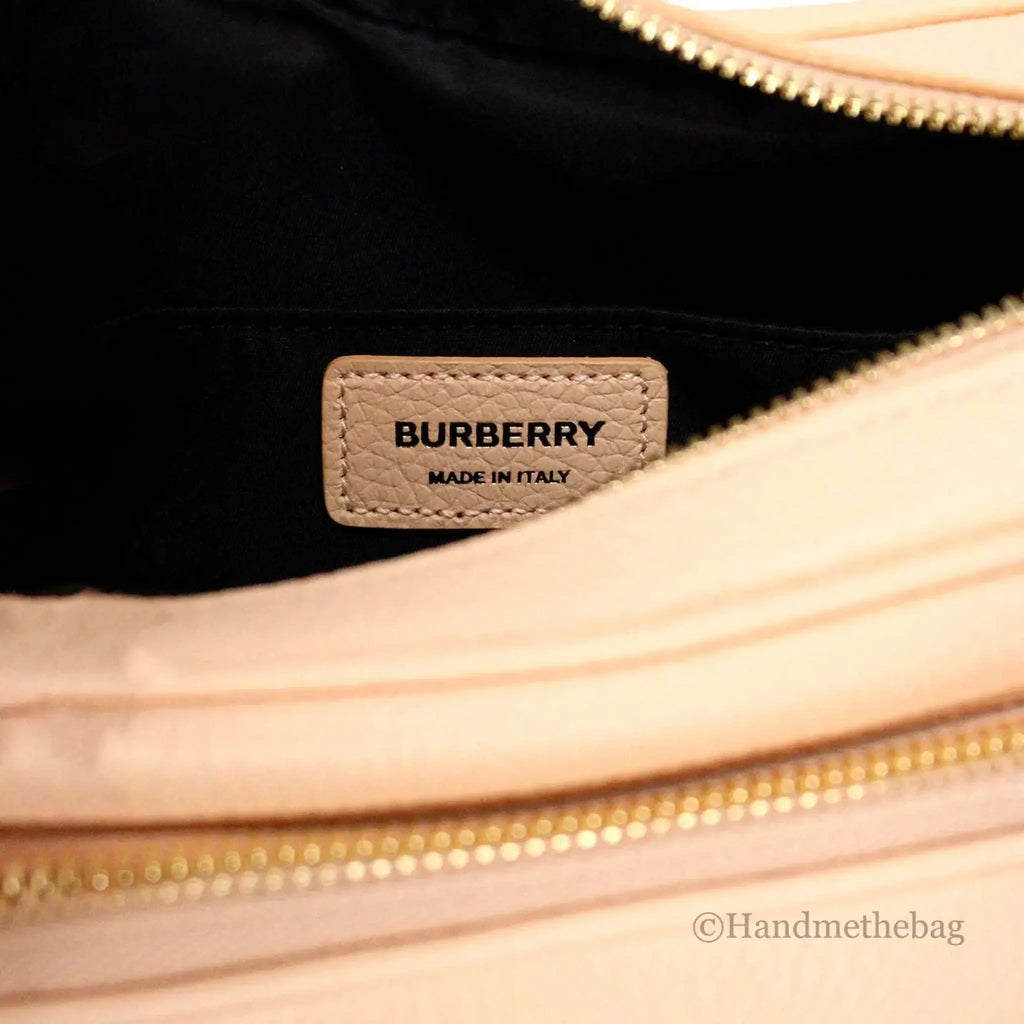 Burberry small peach pink leather camera crossbody bag with adjustable strap and zip pocket.