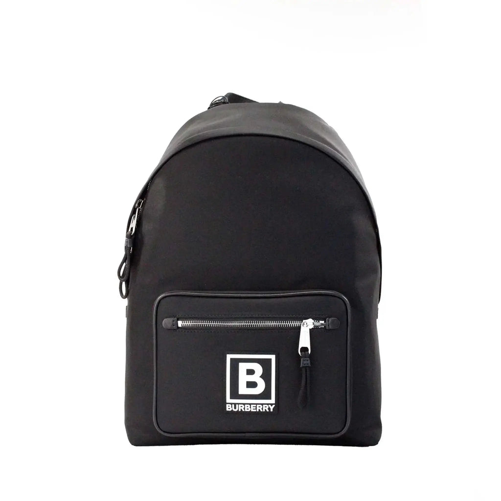 Burberry Abbeydale black nylon backpack with branded stamp, zip pockets, adjustable straps, and top handle.